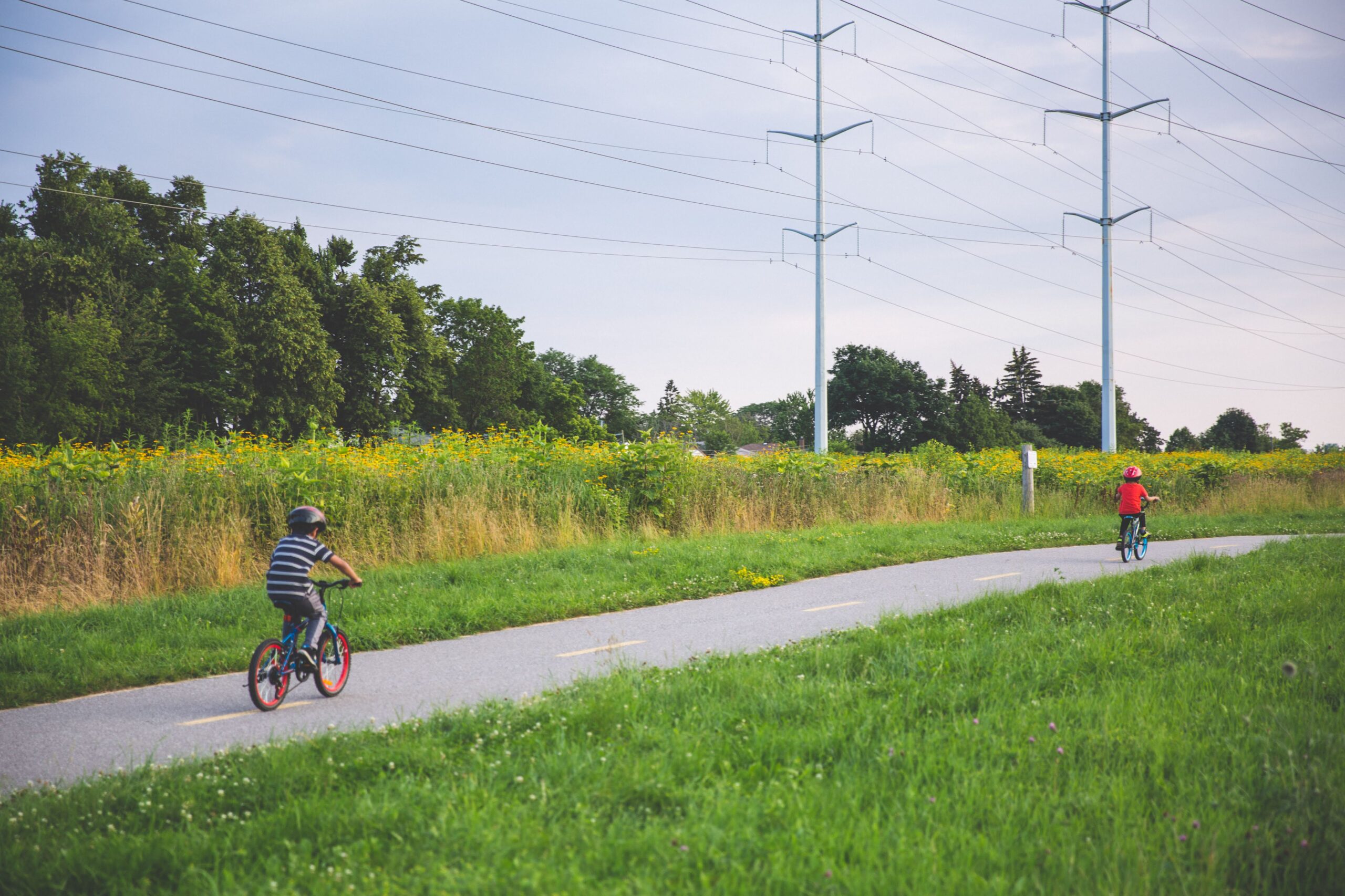 Two children cycling on a bike path